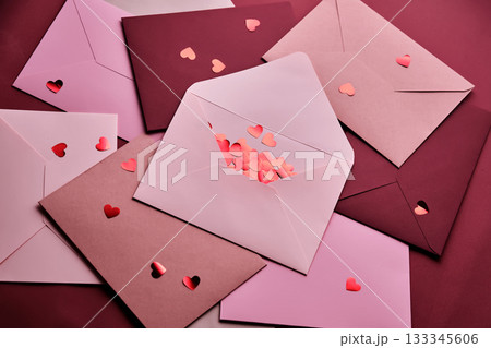 Heart confetti spilling from love letter envelopes 133345606