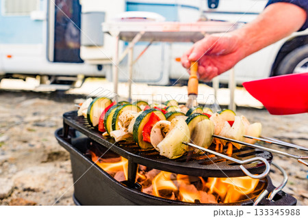 Grilled vegetables on barbecue grill. Rv in the distance 133345988