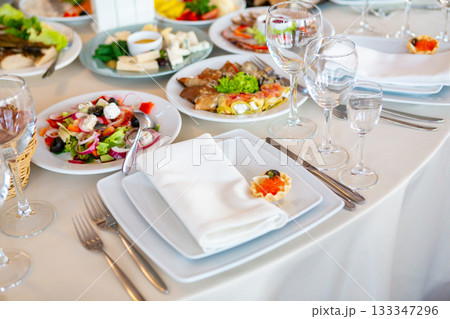 Elegant Dining Setup With Assorted Dishes at a Restaurant During Daytime Gathering 133347296
