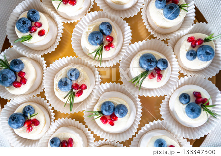 Delicious Mini Desserts Topped With Blueberries and Raspberries on a Decorative Platter 133347300