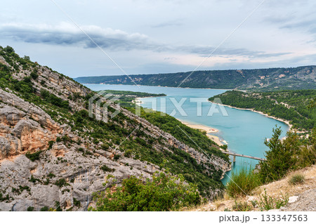 The lake Lac de Sainte-Croix in France has clear cyan water. The Verdon River flows from the Verdon Canyon into the lake The lake Lac de Sainte-Croix in France has clear cyan water. The Verdon River flows from the Verdon Canyon into the lake 133347563