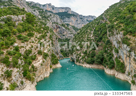 Tourists enjoying turquoise waters of the Verdon River in France, paddling pedal boats and kayaks on a sunny day 133347565