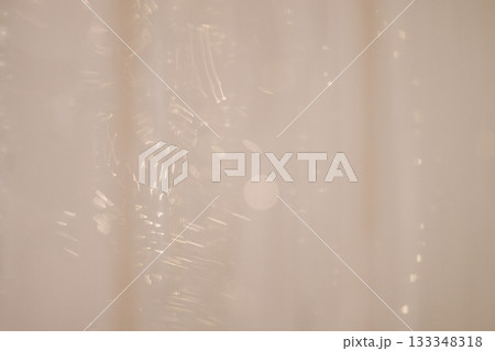 Soft beige holiday background with silver garland and ornaments 133348318