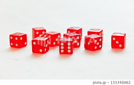 Ten red translucent craps dices on white board showing different numbers Ten red translucent craps dices on white board showing different numbers 133348862