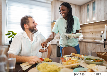Joyful dinner with tasty food in a cozy kitchen Joyful dinner with tasty food in a cozy kitchen 133348900