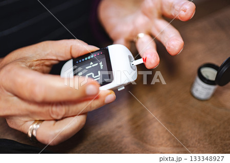 Monitoring blood sugar levels at home during a health check 133348927
