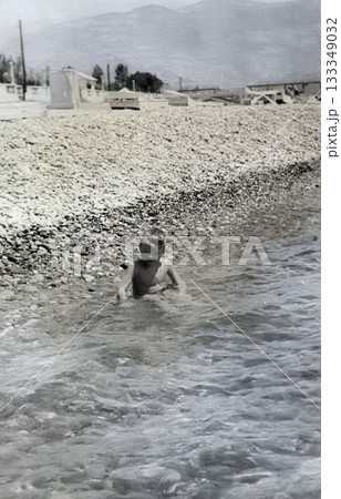 Vintage portrait of a five-year-old boy playing in the sea. USSR. Retro photo from 1965. Vintage portrait of a five-year-old boy playing in the sea. USSR. Retro photo from 1965. 133349032