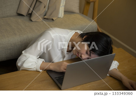 夜リビングでパソコンを見る若い女性 夜リビングでパソコンを見る若い女性 133349360