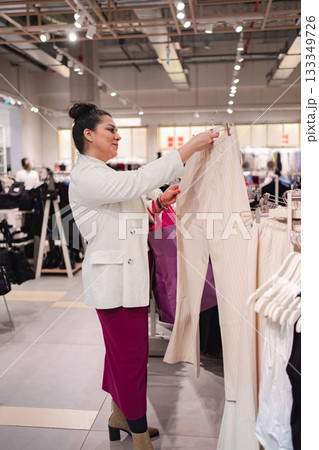 Stylish shopper explores fashion choices in a vibrant boutique Stylish shopper explores fashion choices in a vibrant boutique 133349726