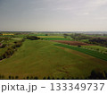 green field in countryside at sunset in the evening light. beautiful spring landscape 133349737