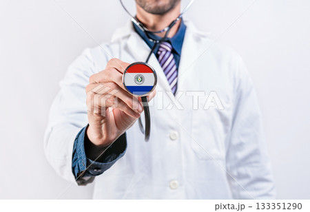 Paraguay healthcare system, doctor holding stethoscope. Paraguay health and medical insurance concept Paraguay healthcare system, doctor holding stethoscope. Paraguay health and medical insurance concept 133351290