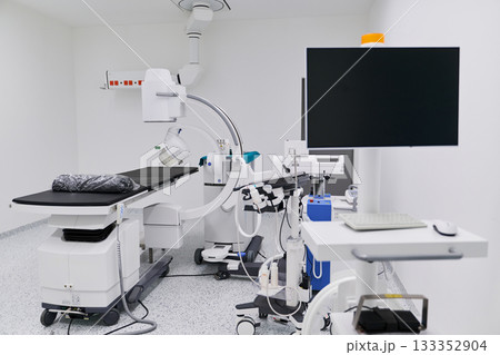 Modern medical examination room equipped with advanced imaging technology and tools for patient diagnostics Modern medical examination room equipped with advanced imaging technology and tools for patient diagnostics 133352904
