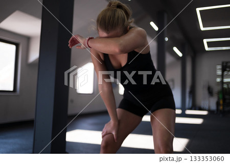 Young woman exercising in a gym during a workout session focusing on fitness and health Young woman exercising in a gym during a workout session focusing on fitness and health 133353060