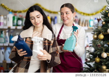 Saleswoman happily offers the customer cleansing sprays at Christmas Saleswoman happily offers the customer cleansing sprays at Christmas 133353126