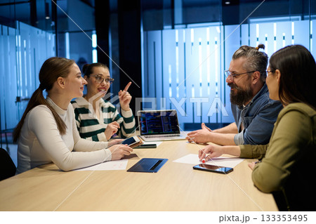 Group of diverse coworkers having a serious discussion around a conference table, led by a bearded male manager, representing teamwork, leadership, and strategy development in a modern business Group of diverse coworkers having a serious discussion around a conference table, led by a bearded male manager, representing teamwork, leadership, and strategy development in a modern business 133353495