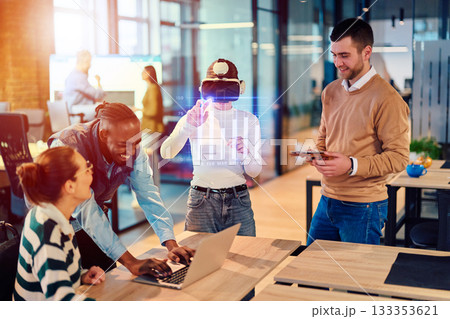 Diverse creative team experimenting with virtual reality headset and digital data visualization in a modern office. Concept of innovation, teamwork, and future technology collaboration. 133353621