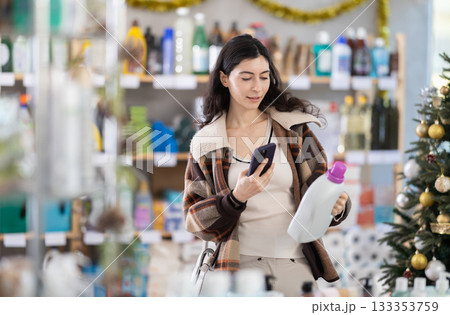 Woman scanning detergent on her phone 133353759