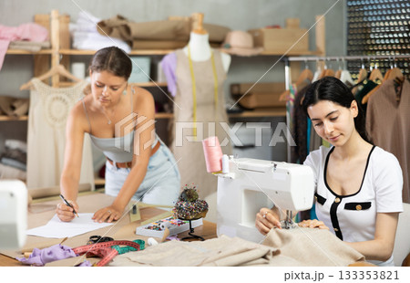Female dressmakers working together in a sewing workshop 133353821