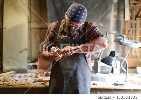 Craftsman shaping wooden toy in workshop, artisan carving wood, handmade crafts, woodworking, carpentry, hobby, small business, creative occupation, skilled labor, traditional craft Craftsman shaping wooden toy in workshop, artisan carving wood, handmade crafts, woodworking, carpentry, hobby, small business, creative occupation, skilled labor, traditional craft 133353838