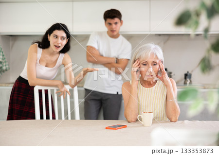 Portrait of thoughtful elderly woman who had conflict with adult children while cooking dinner in kitchen Portrait of thoughtful elderly woman who had conflict with adult children while cooking dinner in kitchen 133353873