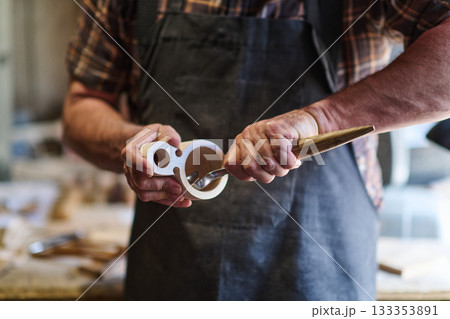 Woodworker shaping wooden cup with hand tools, artisan crafting handmade product, close up of hands working in workshop, woodworking and carpentry concept, craftsperson at work 133353891