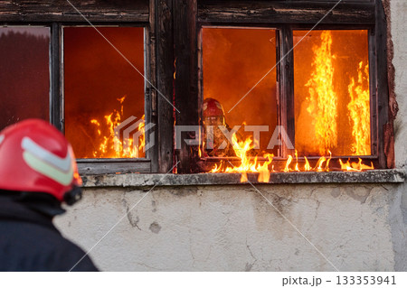 Firefighters battling flames in burning building, risking lives, firemen extinguishing blaze, emergency response, danger, rescue operation, dramatic scene, firefighters in action Firefighters battling flames in burning building, risking lives, firemen extinguishing blaze, emergency response, danger, rescue operation, dramatic scene, firefighters in action 133353941