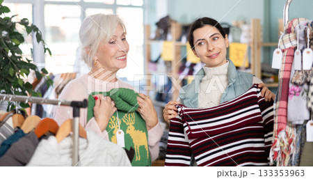 Regular customer mature woman and Armenian girl choose color and style of sweater 133353963