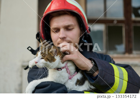 Firefighter rescues cat from burning building, a hero in action, saving a pet, wearing a helmet, outdoor scene, building damage, rescue operation, brave man, animal care Firefighter rescues cat from burning building, a hero in action, saving a pet, wearing a helmet, outdoor scene, building damage, rescue operation, brave man, animal care 133354172