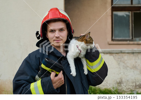 Firefighter rescues a cat from a burning building, hero holding a rescued pet, rescue operation, urban scene, firefighter in uniform, saving animal, outdoor setting 133354195