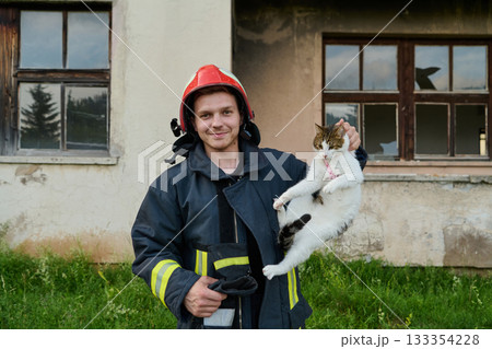 Firefighter rescues a cat from a burning building, hero holding a rescued pet, rescue operation, urban scene, firefighter in uniform, saving animal, outdoor setting Firefighter rescues a cat from a burning building, hero holding a rescued pet, rescue operation, urban scene, firefighter in uniform, saving animal, outdoor setting 133354228