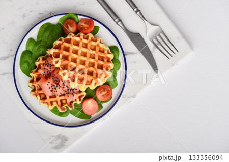 Homemade waffles with lightly salted salmon, spinach and cherry tomatoes 133356094