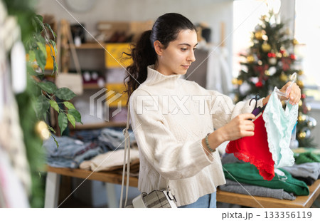 Armenian woman choosing panties in a Christmas clothing store Armenian woman choosing panties in a Christmas clothing store 133356119