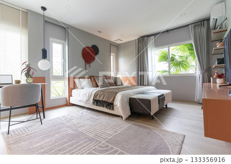Modern stylish bedroom with brown and leather pillows setting. Large art piece on wall. Modern stylish bedroom with brown and leather pillows setting. Large art piece on wall. 133356916