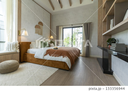 Big bedroom in cottage style with brown and green pillow. Wall lamp and wall art on wall. Big bedroom in cottage style with brown and green pillow. Wall lamp and wall art on wall. 133356944