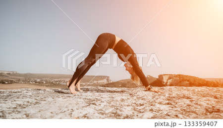 Woman Practicing Yoga in a Mountainous Landscape 133359407
