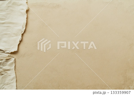 A small piece of torn paper is lying on a patch of sand nearby. AI-generated content. A small piece of torn paper is lying on a patch of sand nearby. AI-generated content. 133359907