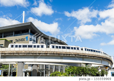 A train on the Wenhu or Brown Line of the Taipei MRT passes by the Taipei Nangang Exhibition Center Hall 1. 133359969
