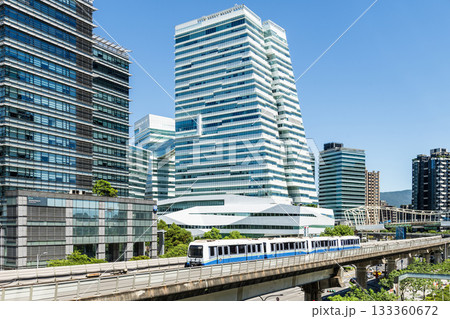 A train on the Wenhu or Brown Line of the Taipei MRT passes by the modern metropolis building in Nangang Software Park Area. 133360672
