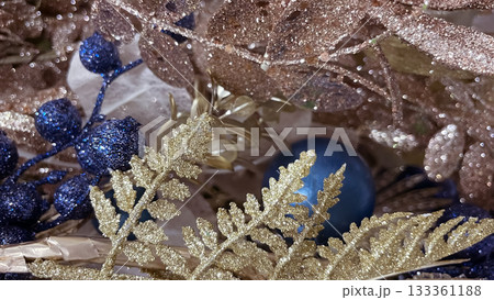 Luxury gold and glittering blue Christmas ornaments on a festive evergreen branch Luxury gold and glittering blue Christmas ornaments on a festive evergreen branch 133361188
