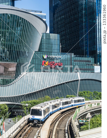 A train on the Wenhu or Brown Line of the Taipei MRT passes by the Mitsui Shopping Park LaLaport Taipei Nangang. 133361960