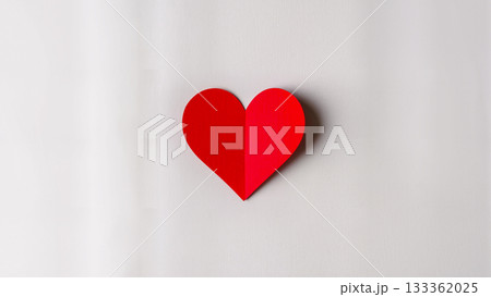 A voluminous red paper heart with a shadow on a clean light background. Minimalism. 133362025