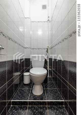 Modern Bathroom Interior with White Toilet and Tile Walls Modern Bathroom Interior with White Toilet and Tile Walls 133362038