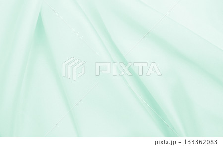 Smooth elegant green silk or satin luxury cloth texture as abstract background. Luxurious background design 133362083