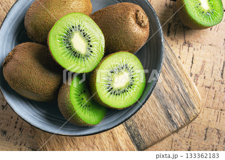 Kiwi fruits in wooden bowl Kiwi fruits in wooden bowl 133362183