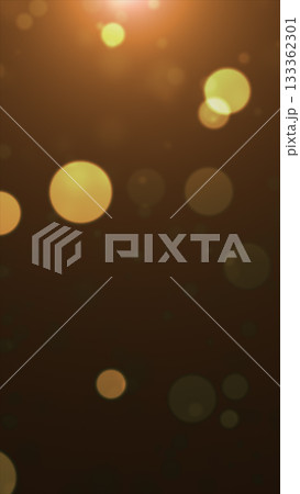 Soft glowing golden bokeh lights floating on a dark background with a warm dreamy atmosphere 133362301