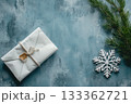 A Christmas gift in white paper with a snowflake on blue. AI-generated content. 133362721