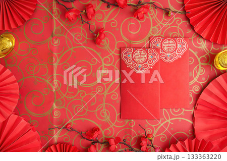 Chinese New Year red envelopes and decorations on ornate background Chinese New Year red envelopes and decorations on ornate background 133363220