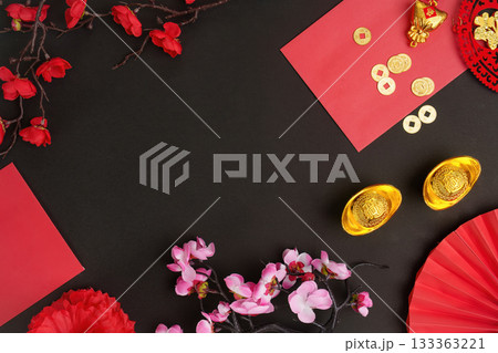 Chinese New Year decorations with red envelopes and gold coins on dark background 133363221