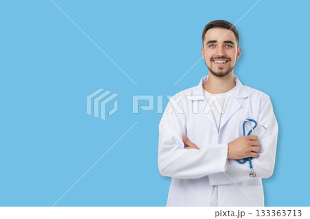 Doctor poses confidently with arms crossed in medical attire Doctor poses confidently with arms crossed in medical attire 133363713