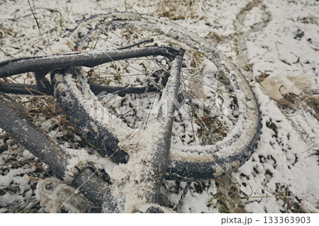 Bicycle in snow and mud in winter against the background of grass Bicycle in snow and mud in winter against the background of grass 133363903
